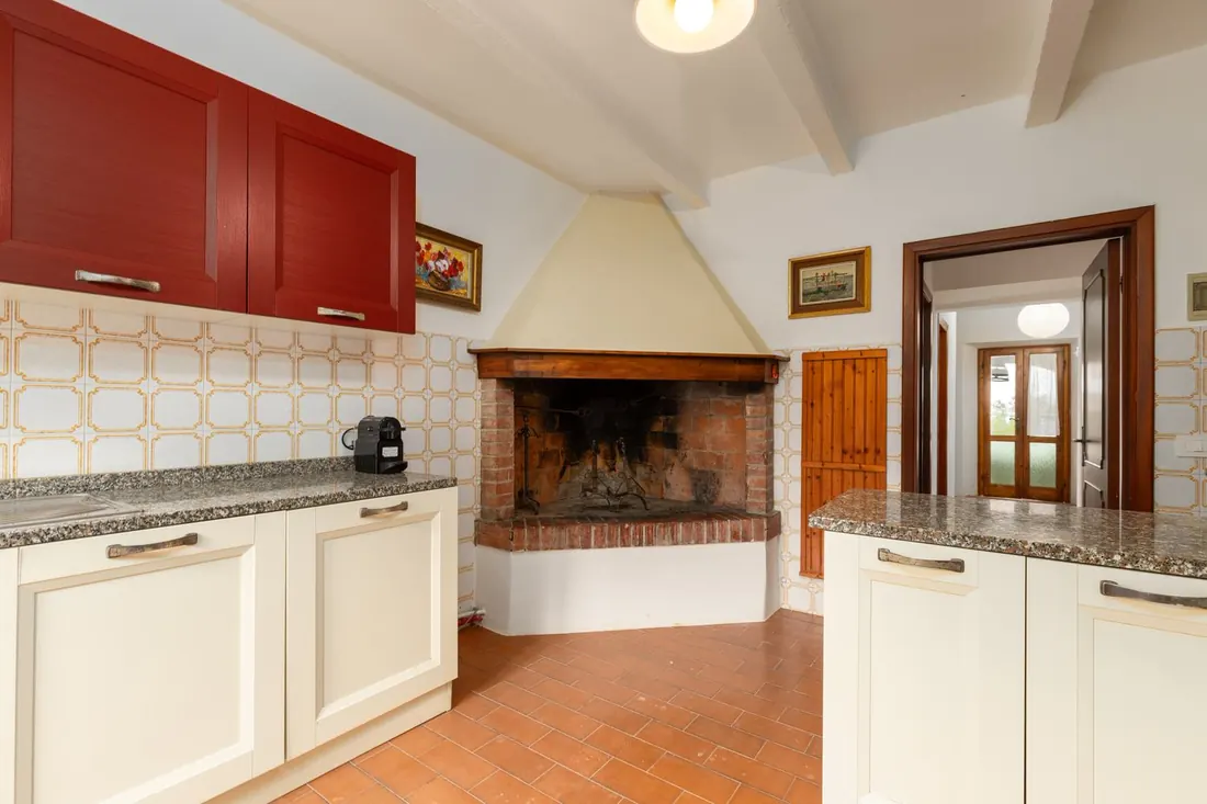 Cucina con camino e piani in granito