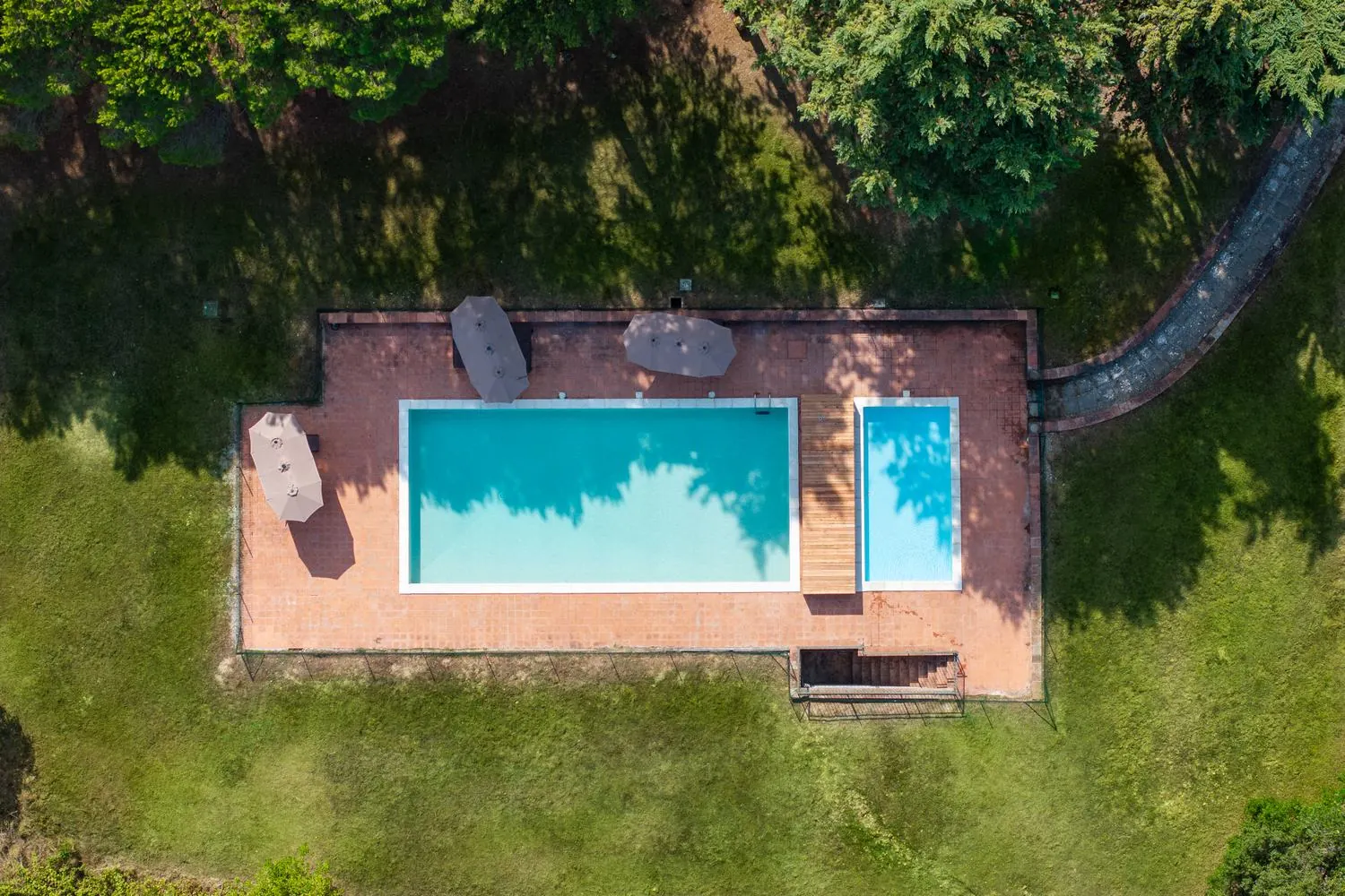 La piscina vista dall'alto, circondata dal bosco